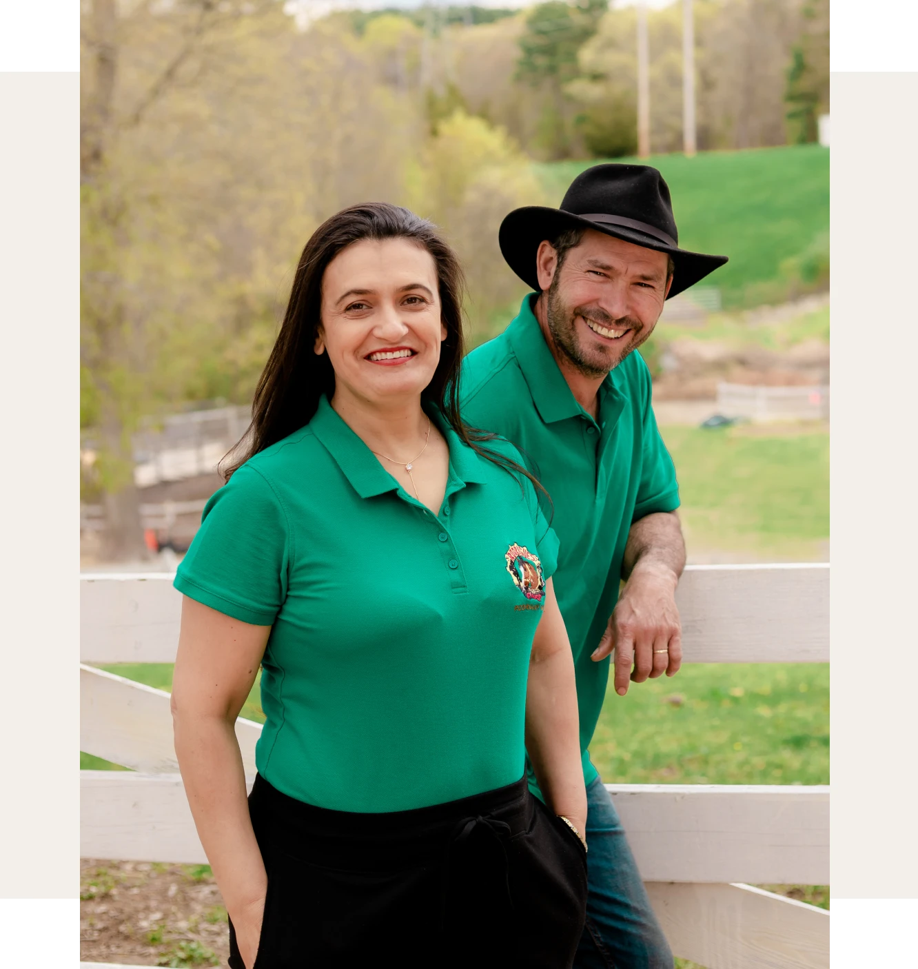 Casal Rodrigues, fundadores da fazenda, sorrindo em frente à cerca da propriedade